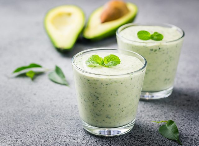 Avocado turmeric green tea smoothie. Selective focus, close up, copy space.