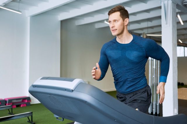 Man running on treadmill at gym