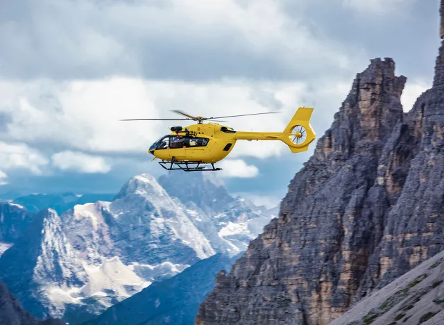 Panoramic flight over the mountains. Air transport. Helicopter flight over the epic landscape. Rescue mission in the wilderness.