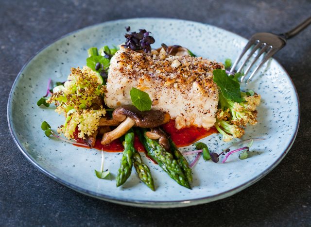 Halibut with hazelnut crust with roast red pepper sauce, asparagus, cauliflower and shiitake mushrooms