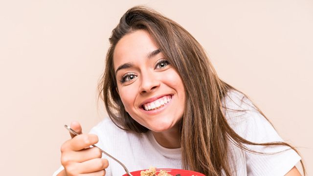 Young caucasian woman having breakfast