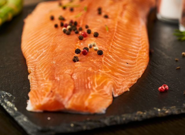 Salmon with black pepper on plate close up.