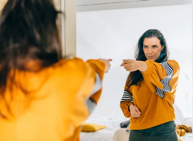 Self,Confident,Single,Woman,Pointing,Finger,At,Her,Reflection,In