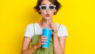 Portrait photo of impressed shocked woman bob brown hair wear 3d glasses specs poued lips drink soda nice film isolated on yellow color background
