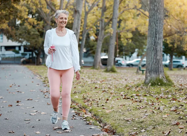 Health, nature and senior woman on walk in the morning for exercise, wellness and fitness in park. Healthy, outdoor and elderly lady in retirement from Australia walking in garden for cardio workout.