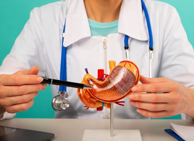 woman doctor pointing at stomach mockup