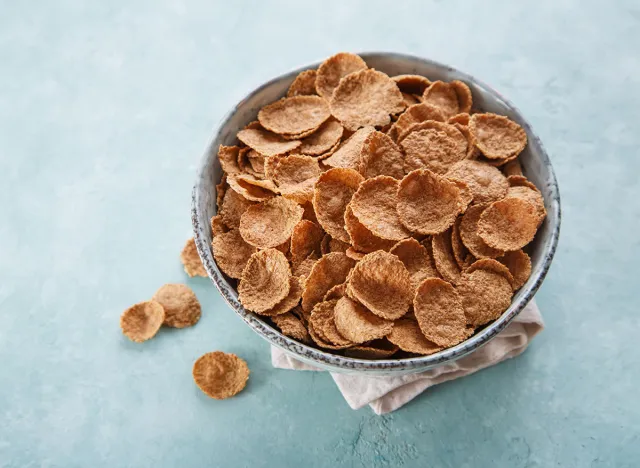 Whole grain cereal in a bow on a blue background