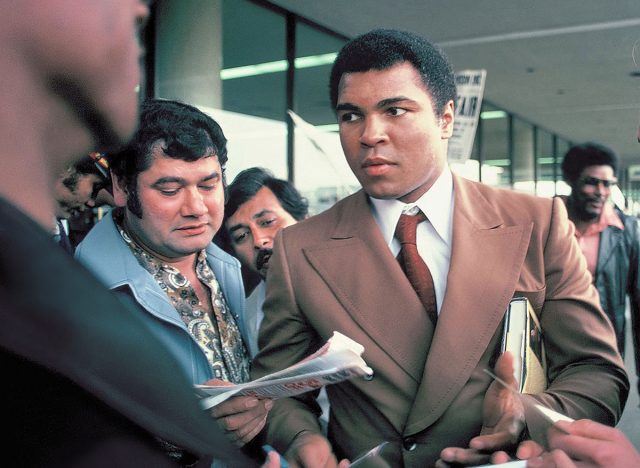 SAN ANTONIO, TEXAS - MARCH 10, 1979: Muhammad Ali signs autographs for fans at the San Antonio International Airport.