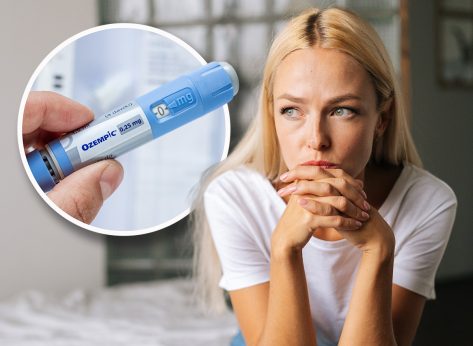 Portrait of depressed woman sitting alone at home and looking away with sad expression holding hands on chin, deep thoughts feeling lonely. Frustrated blonde female pondering make difficult choice.