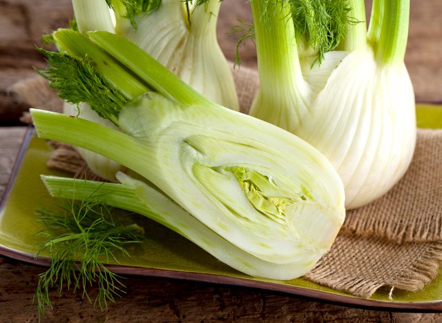 Fresh Florence fennel bulbs or Fennel bulb on wooden background. Healthy and benefits of Florence fennel bulbs