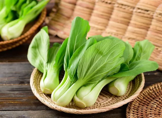 Fresh Bok Choy or Pak Choi(Chinese cabbage) in bamboo basket on wooden background, Organic vegetables