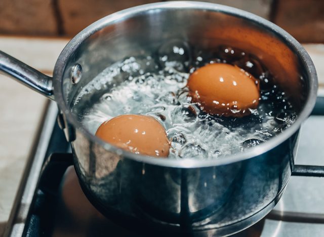 Saucepan with boiling eggs on a gas stove