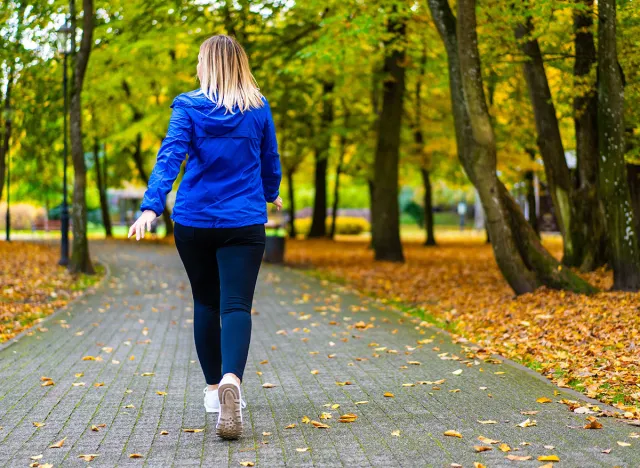 Healthy lifestyle - woman walking in city park