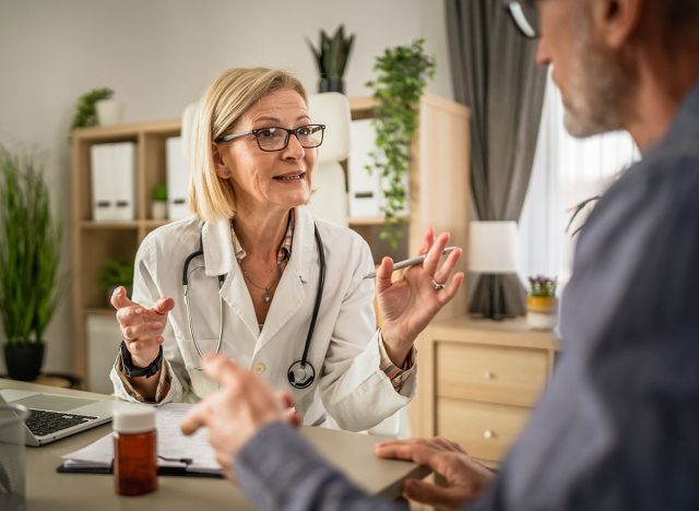 Mature woman doctor talk with patient about diagnose at doctors office