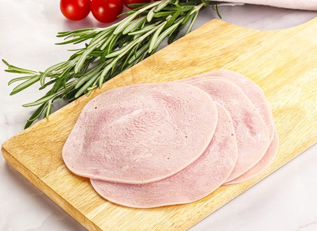 Sliced pork ham for sandwiches over board