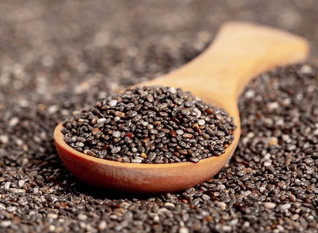 Chia seeds close-up with a wooden spoon. Chia seeds macro. Dry healthy supplement for proper nutrition.