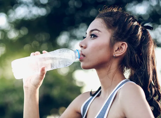 women drinking water on the park