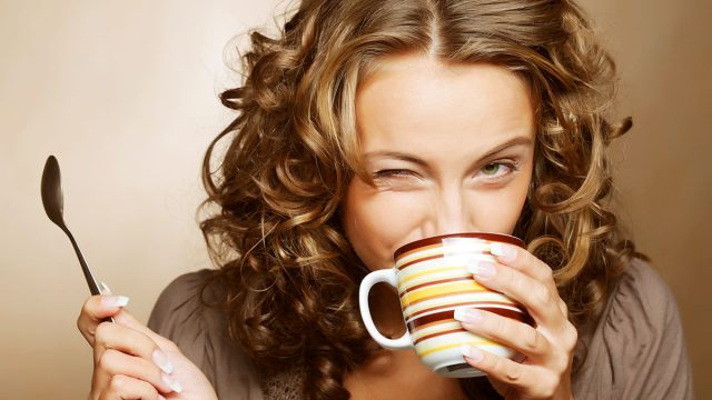 young pretty woman drinking coffee