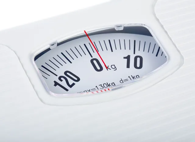 Bathroom scale on white background. Weight loss concept. Weight control by floor scale