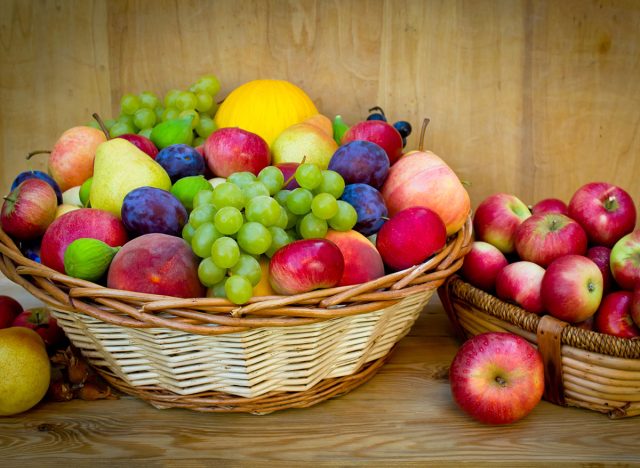 Fresh fruit in the basket on the wooden table