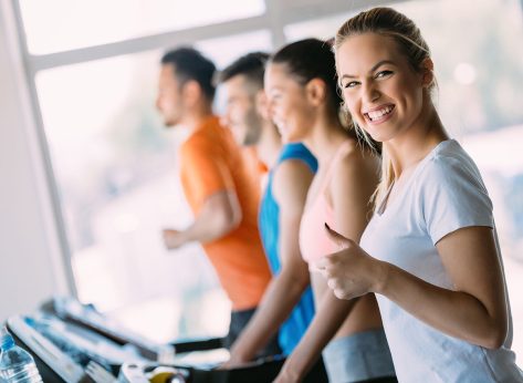 Young attractive woman doing cardio training in gym