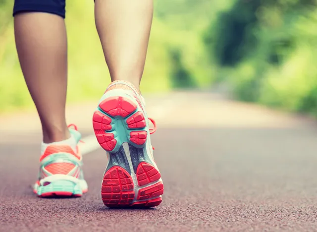 Young woman runner legs ready for running on trail