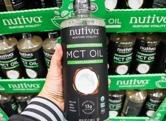 Los Angeles, California, United States - 02-08-2020: A view of a hand holding a bottle of Nutiva Nurture Vitality MCT oil on display at a local big box grocery store.