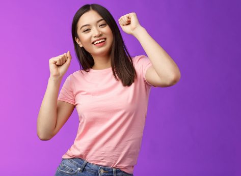 Joyful glamour asian attractive girl having fun enjoy awesome party feeling carefree, fist pump during dance, smiling broadly like good music, attend concert, stand purple background