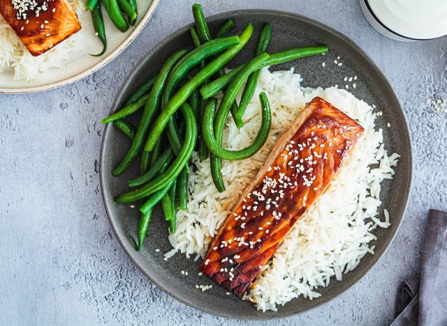 Honey teriyaki salmon with green beans and rice, top view. Asian cuisine recipe.