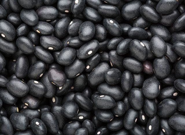 Top view of black Beans. Food background. Close-up. Selective focus.