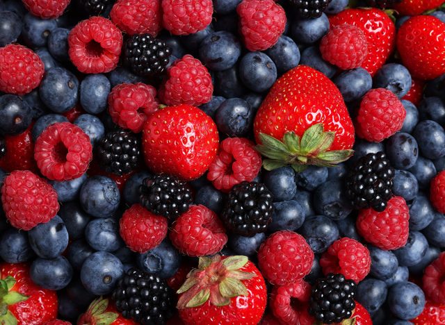 Different fresh ripe berries as background, top view