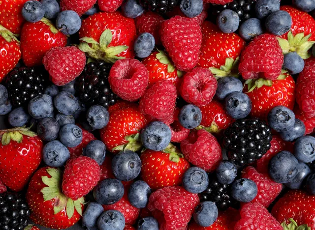 Assortment of fresh ripe berries as background, top view