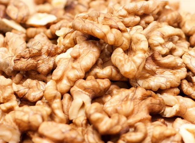 Walnuts close-up. Healthy eating. Background image, Background of walnut halves, Walnuts sold in spice market. Walnuts Help Lower Cholesterol. Good grains eat healthy.