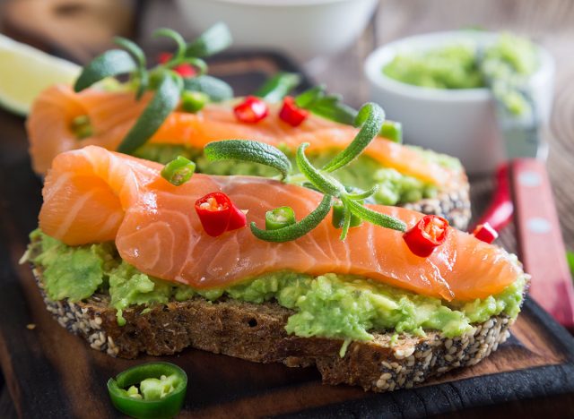 Whole grain bread with avocado paste and salmon