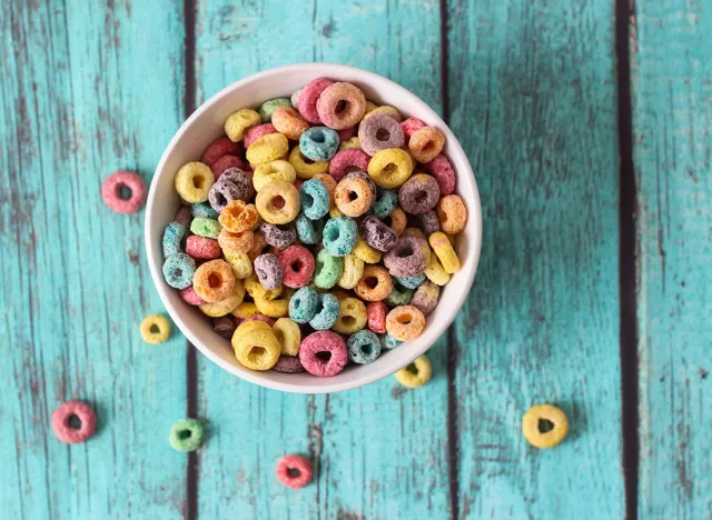 multicolored cereals in a white bowl on blue background