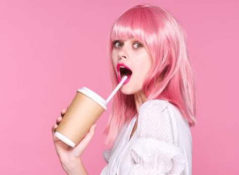 Beautiful woman with pink hair doll cup of coffee