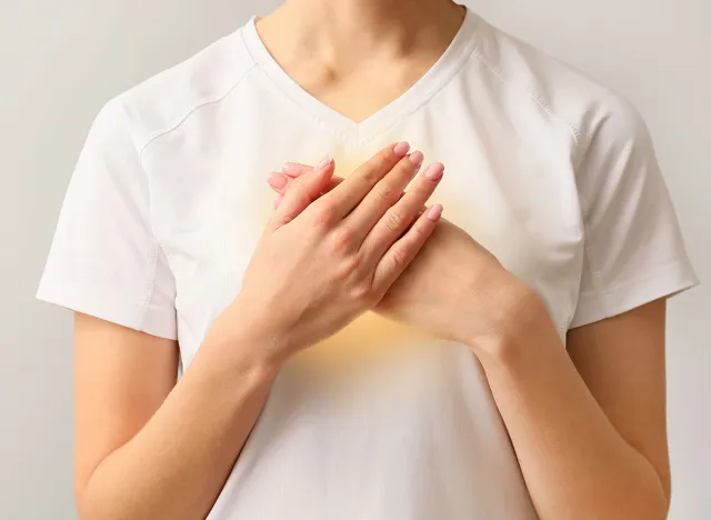 Meditating young woman on light background