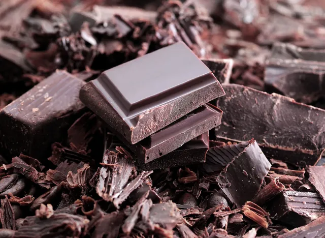 Dark chocolate. Broken chocolate bar on kitchen table