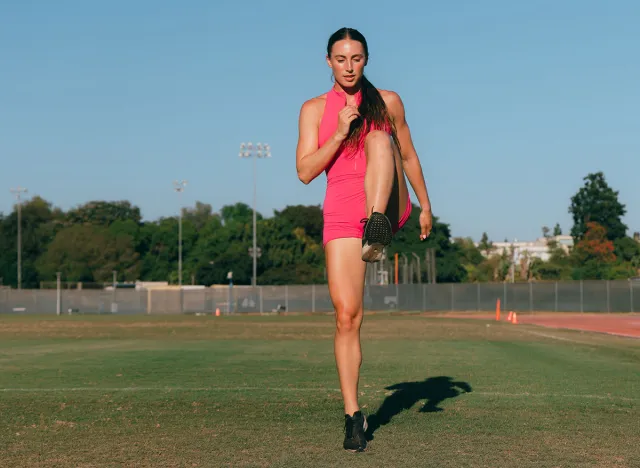 Female athlete doing high knee march during drills