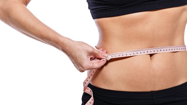 Girl,Measuring,Waist,Circumference,After,A,Grueling,Workout,,Isolated,On