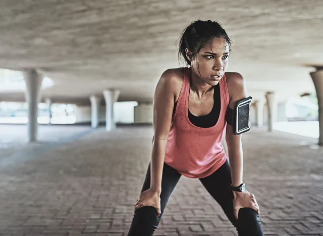 Youve gotta sweat for it. Shot of a sporty young woman taking a break while exercising outdoors.