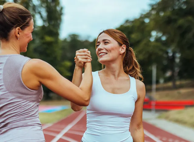 Concept of friendship, physical wellbeing and health. High five, success and fitness friends with goals, motivation and winning mindset in celebration of targets.