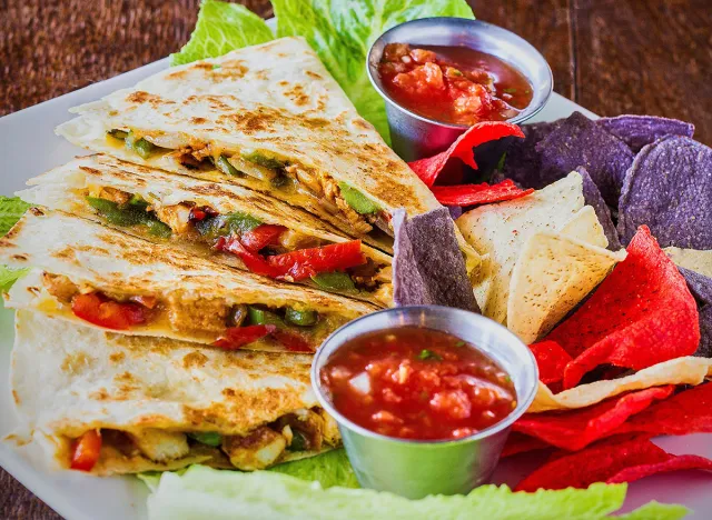 chicken quesadilla with bell peppers and onions, served with salsa and chips