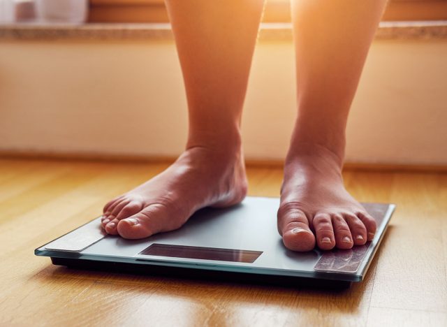 Female bare feet on weight scale