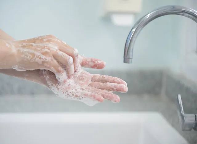 Hygiene and cleaning hands.Washing hands rubbing with soap for corona virus prevention, hygiene to stop spreading coronavirus.Close up woman hand washing in the kitchen.