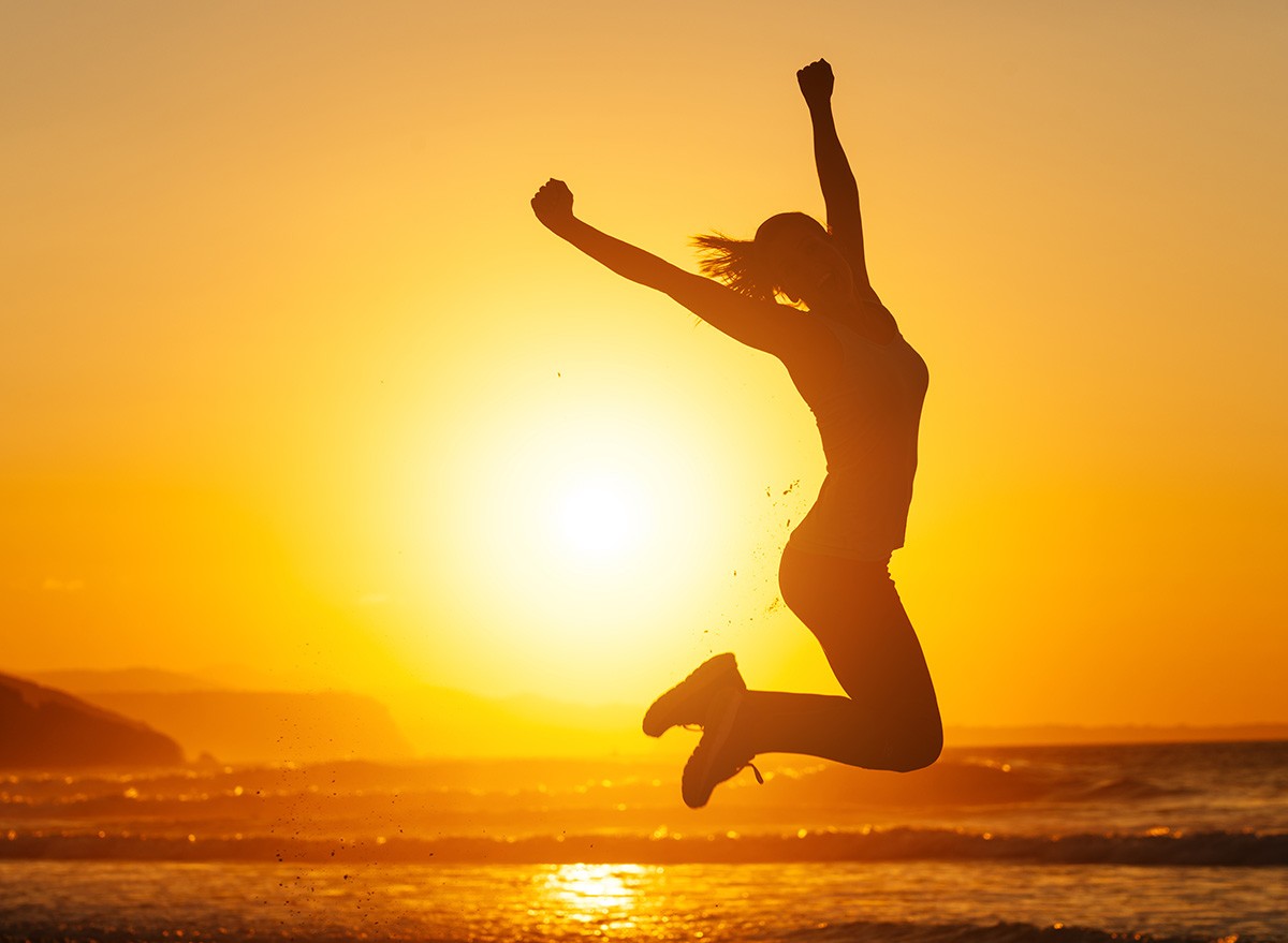 Silhouette,Happy,Joyful,Woman,Jumping,beach,sunset,ocean,sea,celebrate