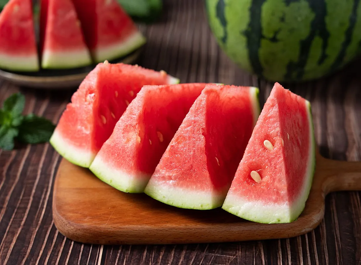 Slices of fresh watermelon on the rustic wooden table