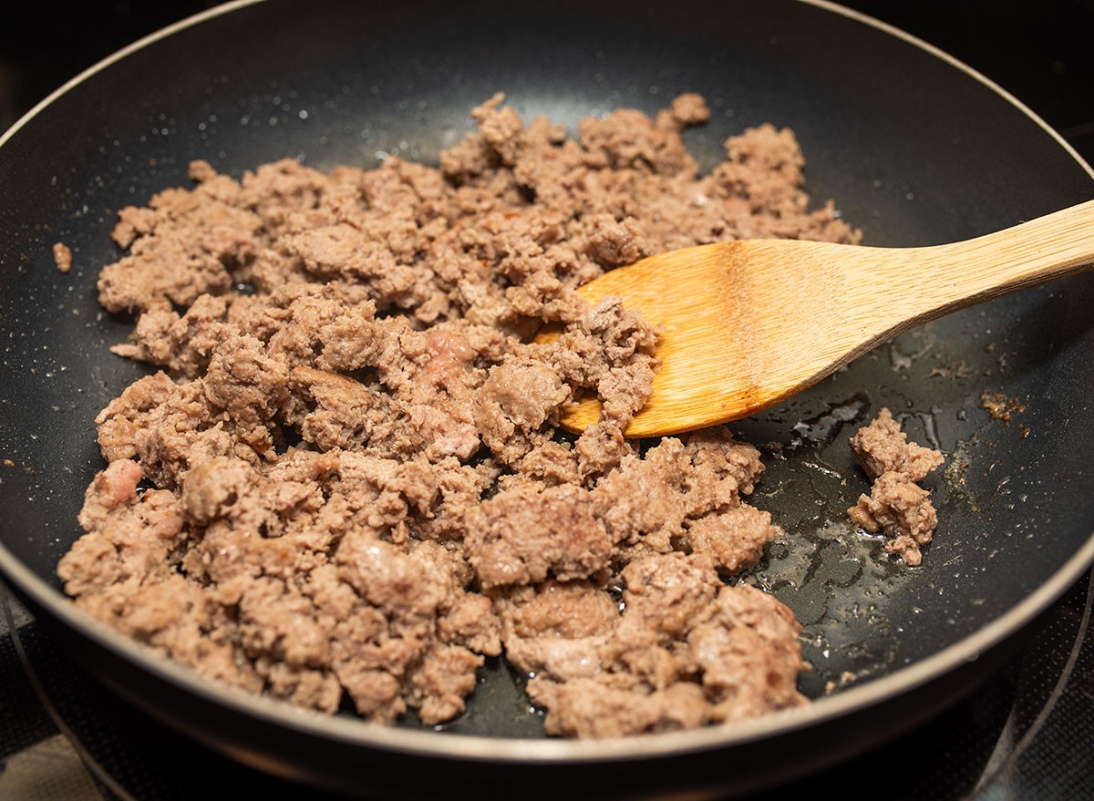 Cooking ground turkey meat in frying pan for a meal prep