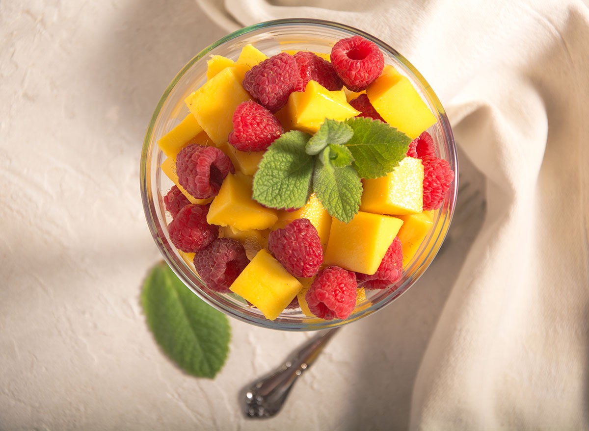Delicious, fresh champagne mangoes and raspberries in a margarita glass, topped with a fresh mint sprig. Wonderful breakfast food, or for any time the need for a healthy snack arises.