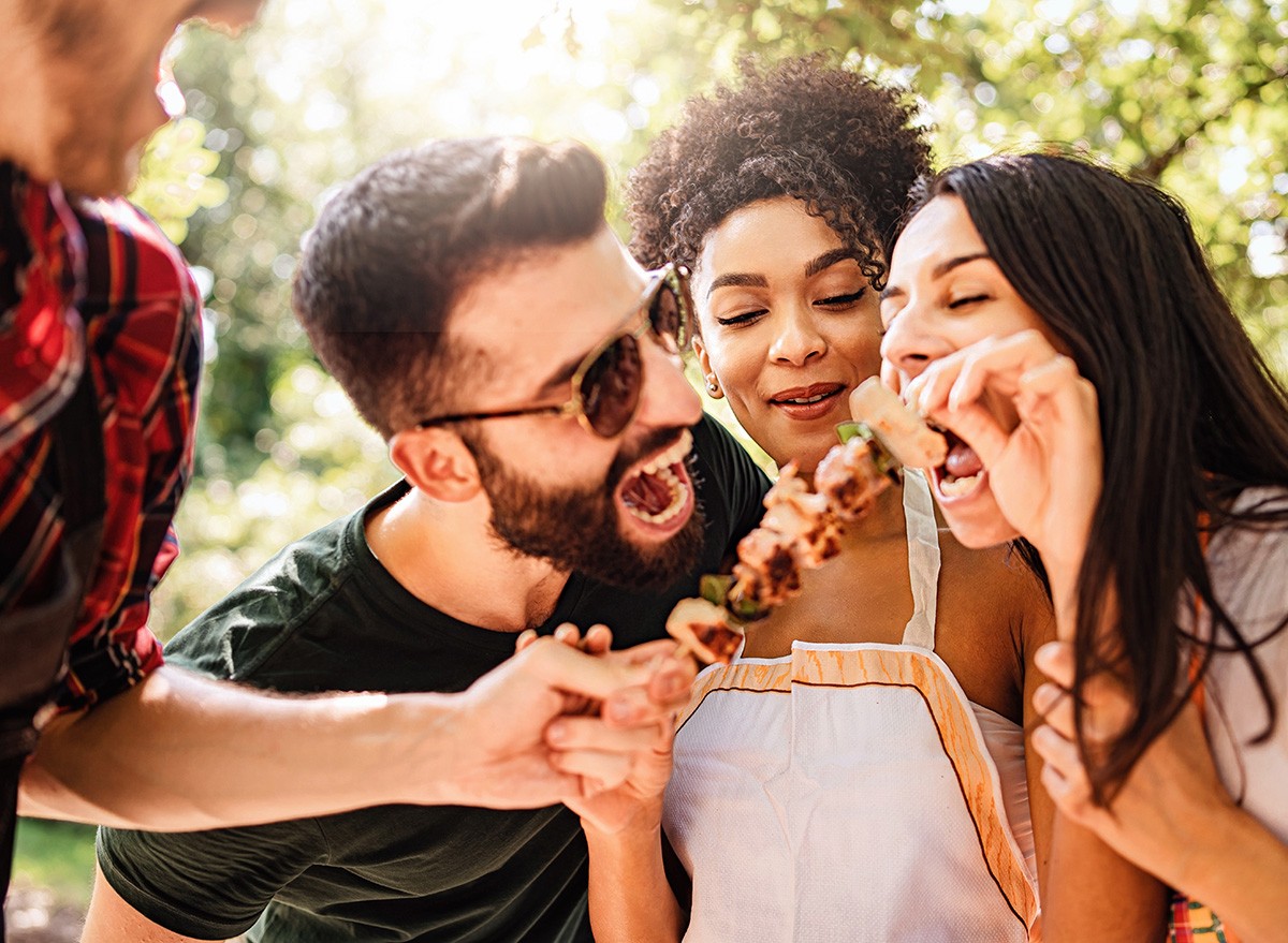 Happy,Multiethnic,Millennials,Playing,Together,Eating,Skewers,And,Eating,Together